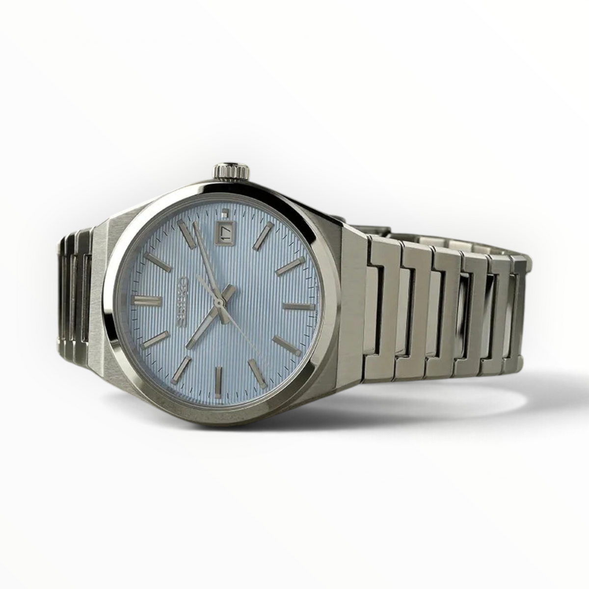SUL EXTRAS Seiko Classic men's watch with a light blue textured dial, silver stainless steel case, and bracelet.