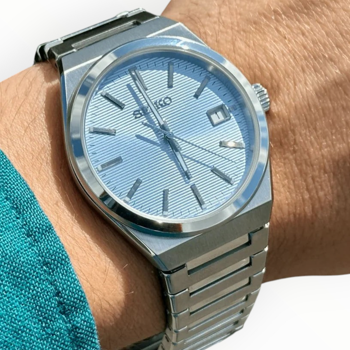 SUL EXTRAS Seiko Classic Icy Peaks watch with a light blue textured dial and silver stainless steel bracelet on wrist