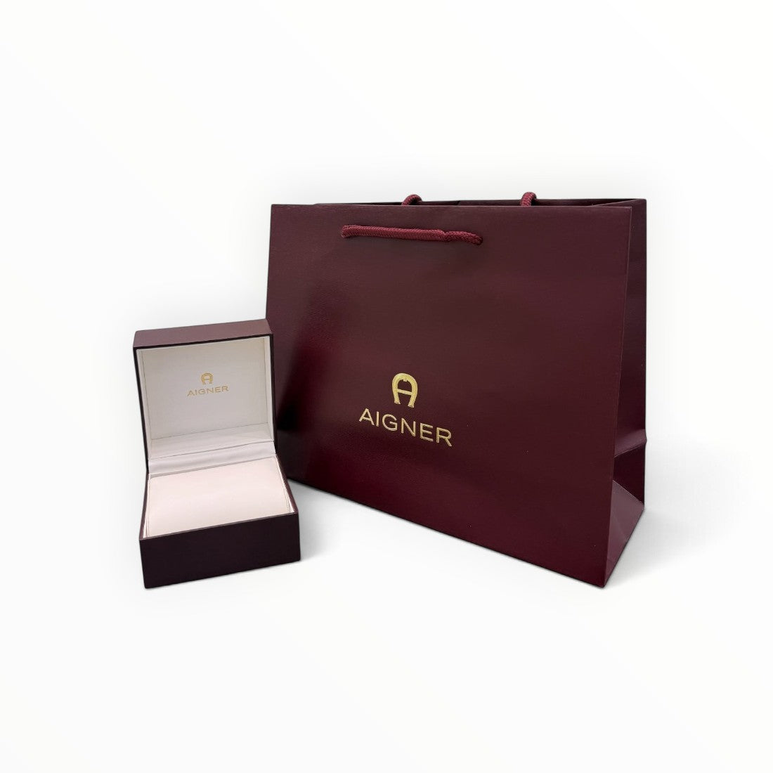 SUL EXTRAS Aigner luxury burgundy gift box and matching shopping bag with gold branding on a white background