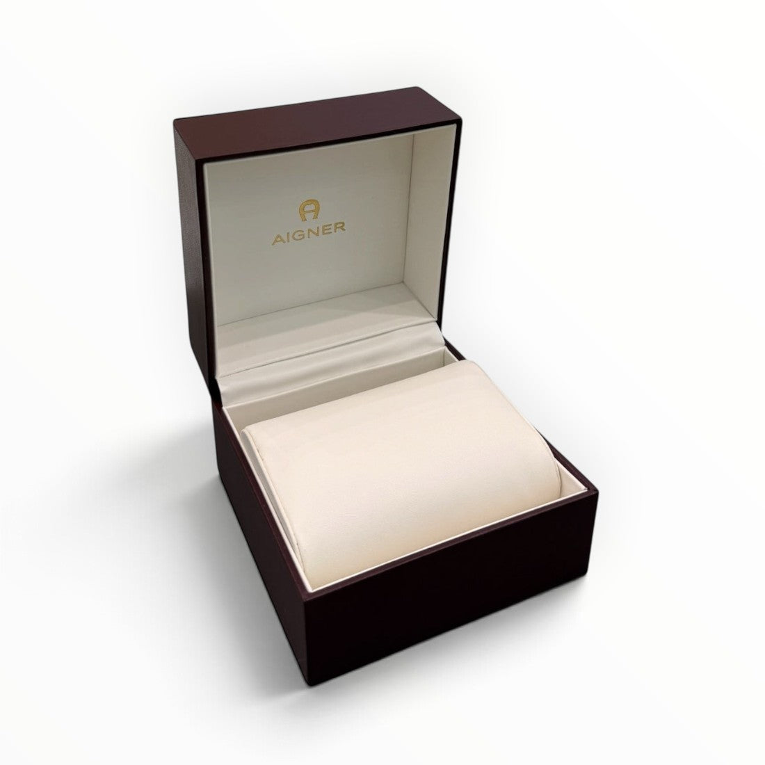 SUL EXTRAS Aigner luxury watch gift box in deep burgundy lacquer with a cream interior cushion and gold logo branding.