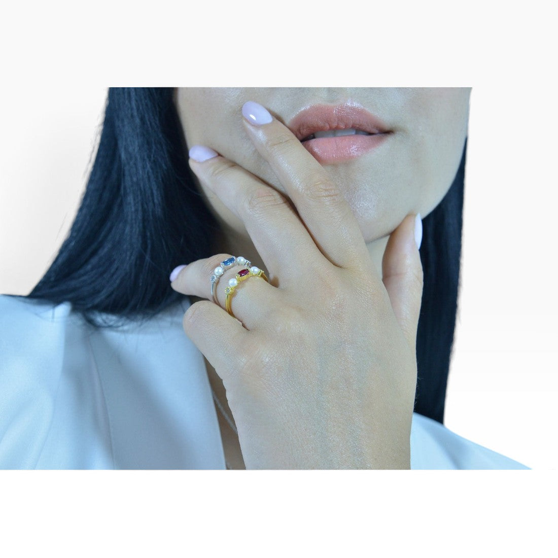 SUL EXTRAS gold plated sterling silver ring with pearl and red zirconia stone worn on a woman's hand