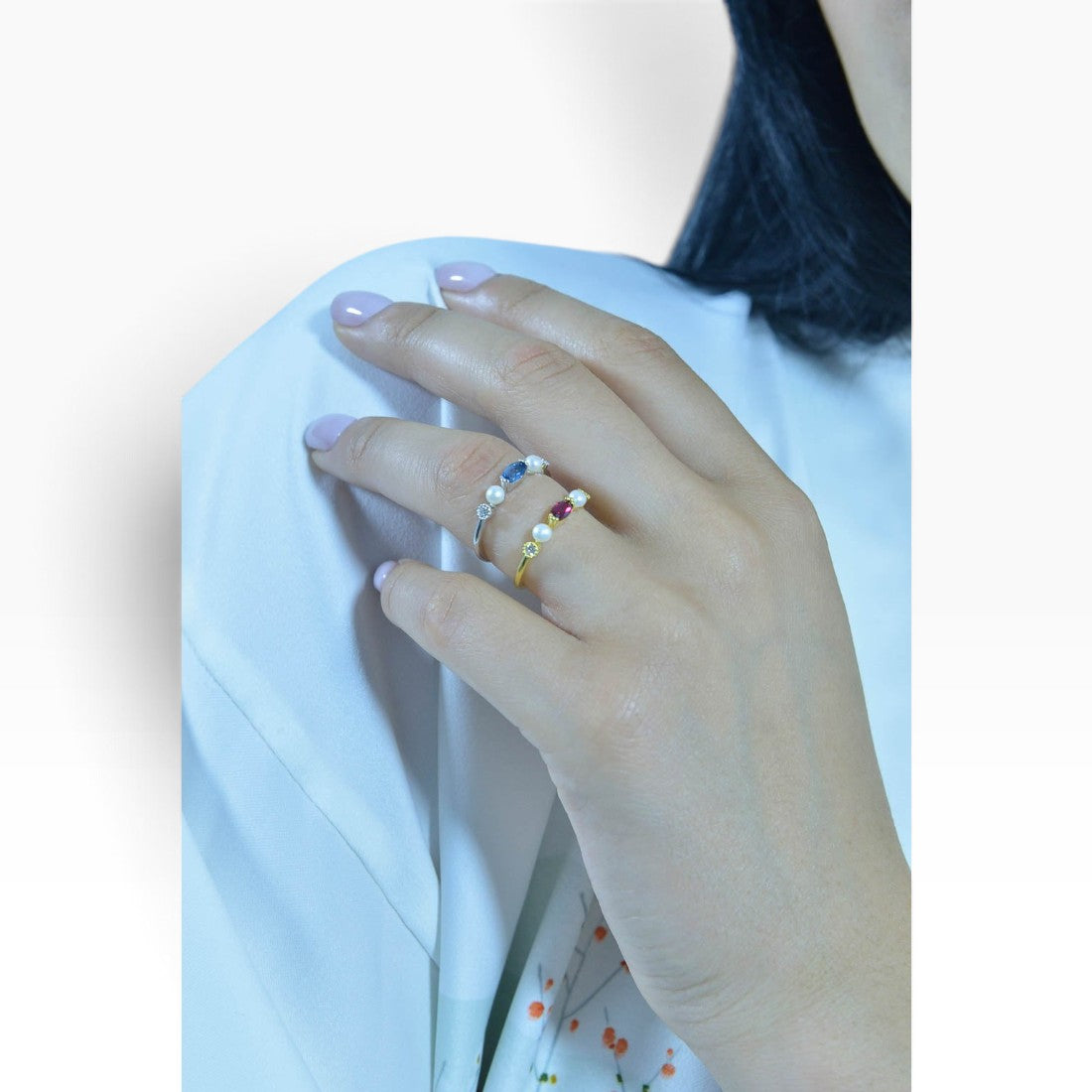 SUL EXTRAS gold-plated sterling silver rings featuring pearls and red and blue zirconia stones worn on a hand