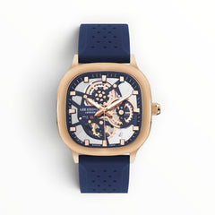 SUL EXTRAS Lee Cooper London cushion-square watch with rose gold case, skeleton dial, and navy blue perforated strap.