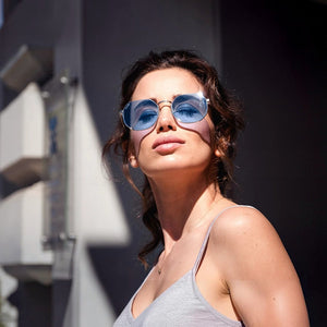 SUL EXTRAS Parade sunglasses featuring oversized geometric round blue lenses and a lightweight metal frame on a model