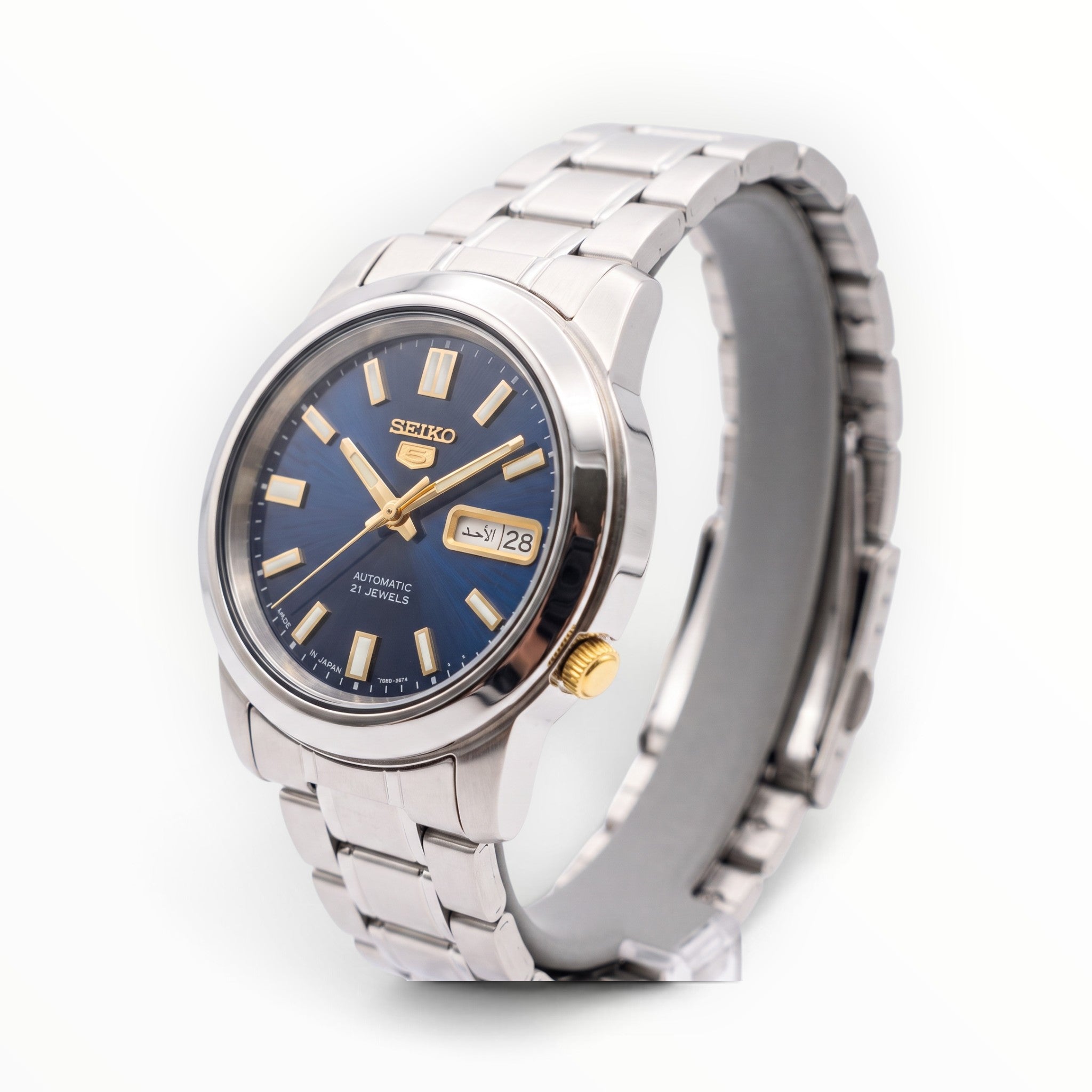 SUL EXTRAS Seiko 5 automatic watch with midnight blue sunburst dial, gold accents, and stainless steel bracelet.