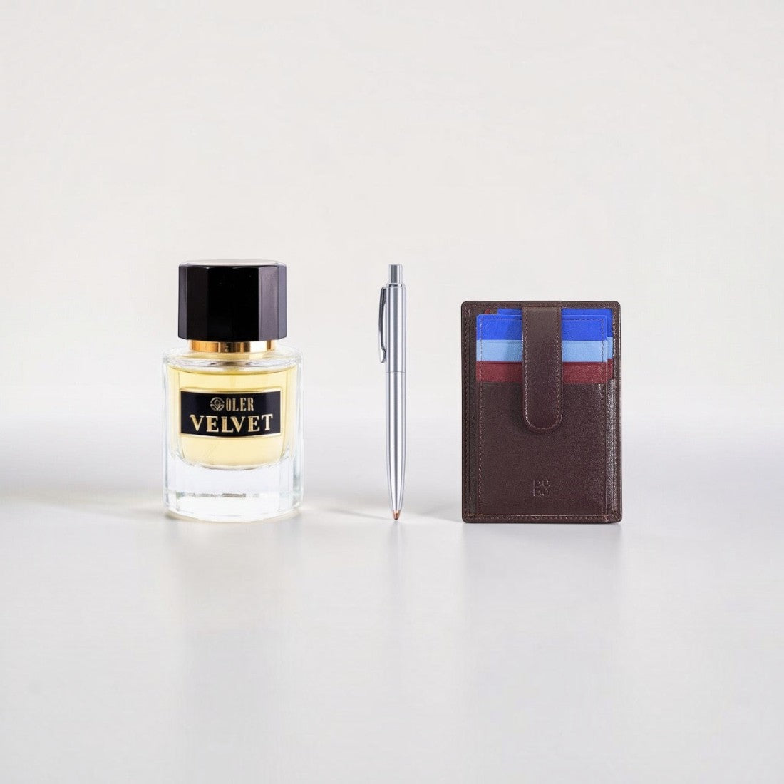 SUL EXTRAS Velvet Trio bundle featuring a perfume bottle, silver Titan steel pen, and brown leather Dudu card holder.