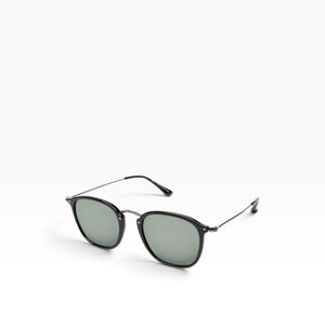 SUL EXTRAS Visi rectangle sunglasses with a shiny black frame and green lenses featuring metal stud accents